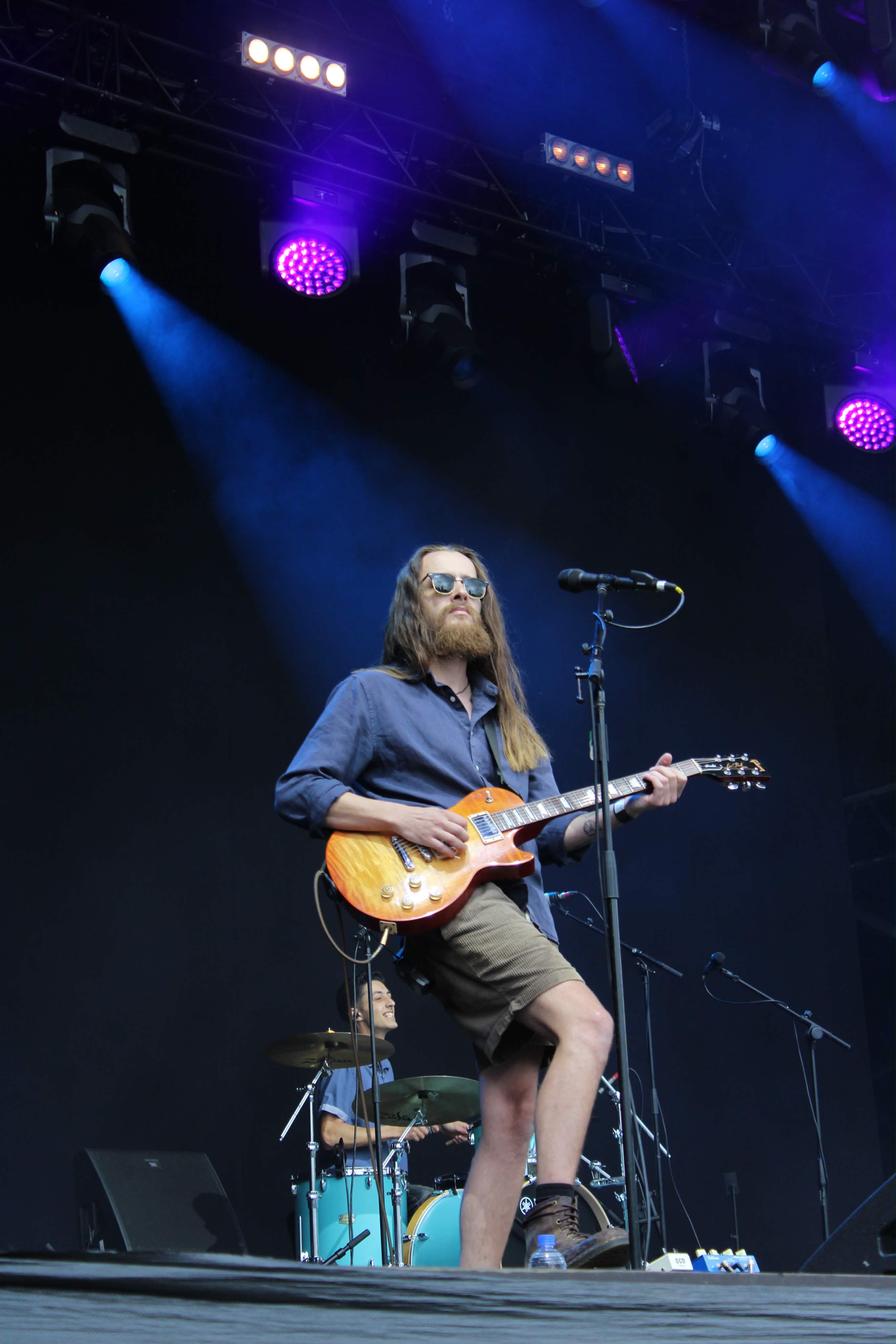 Sam Gale playing guitar on stage